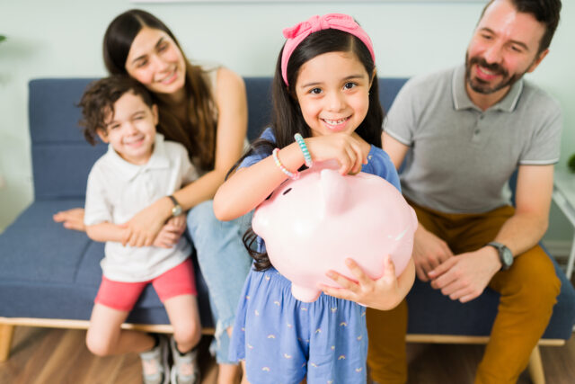 Adorable daughter saving for a family vacation