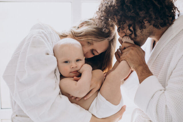 Multicultural family with their little son having fun together