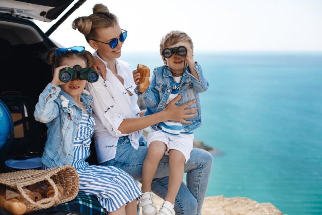 happy-beautiful-mother-kids-travel-by-car-near-sea