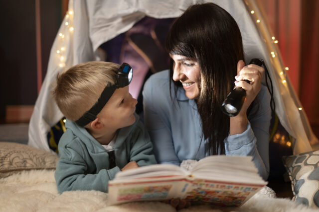 smiley-woman-kid-reading-medium-shot