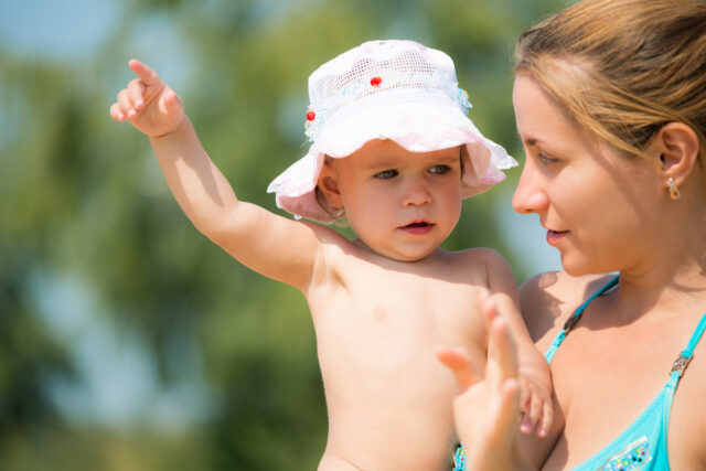 Charming young woman holding little daughter.