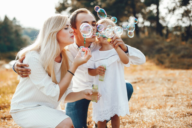 Cute family playing in a summer park