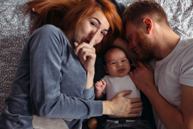 Young parents giving attention to their baby.